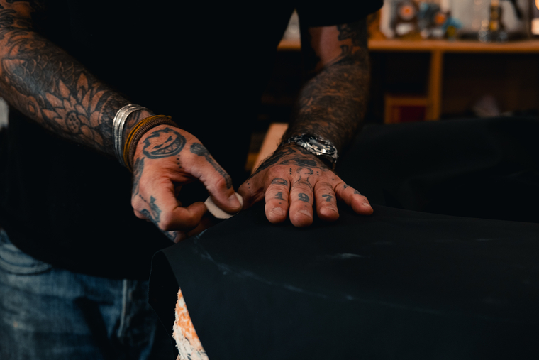 Tattooed working hands banner image